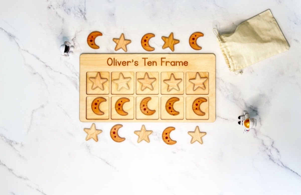 Space-themed wooden ten frame with twenty counters for Montessori math